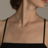 Elegant And Versatile Gold Bean Ingot Classic Necklace worn elegantly by a model with a minimalist outfit.