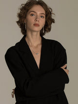 Elegant And Versatile Gold Bean Ingot Classic Necklace worn by a model, showcased in a sophisticated black outfit.