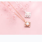 Women's Silver Necklace Pendant Sweet Square Pattern on a pink background with floral accents.